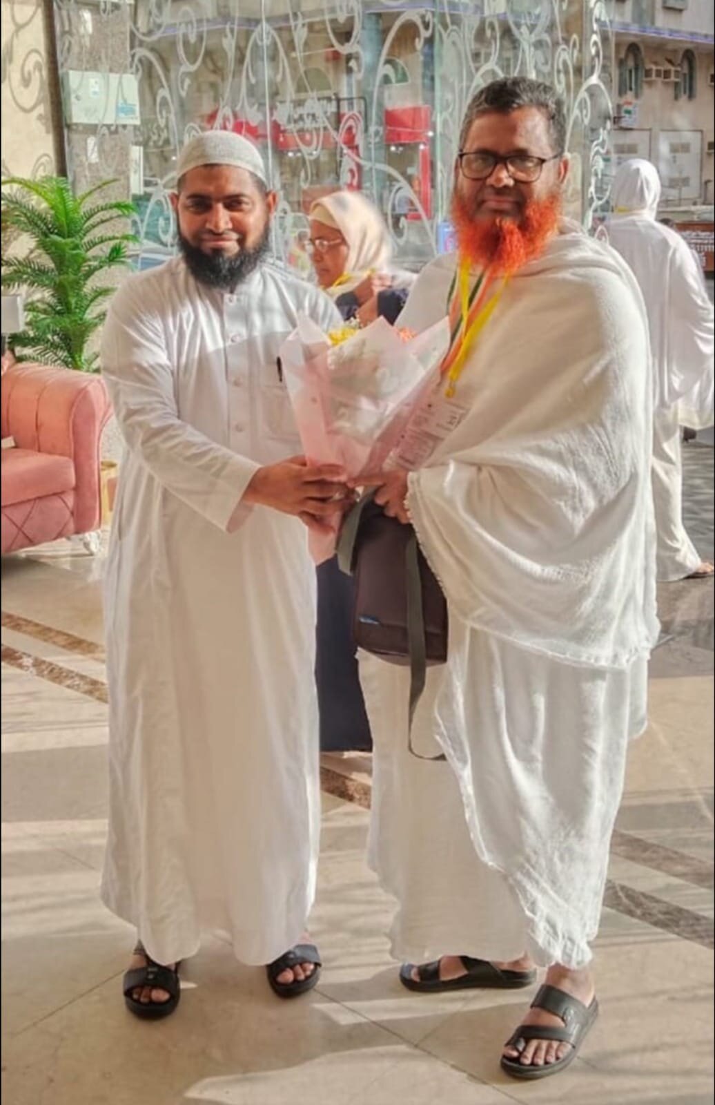 Hafiz Rafiqul Islam being felicitated with flowers